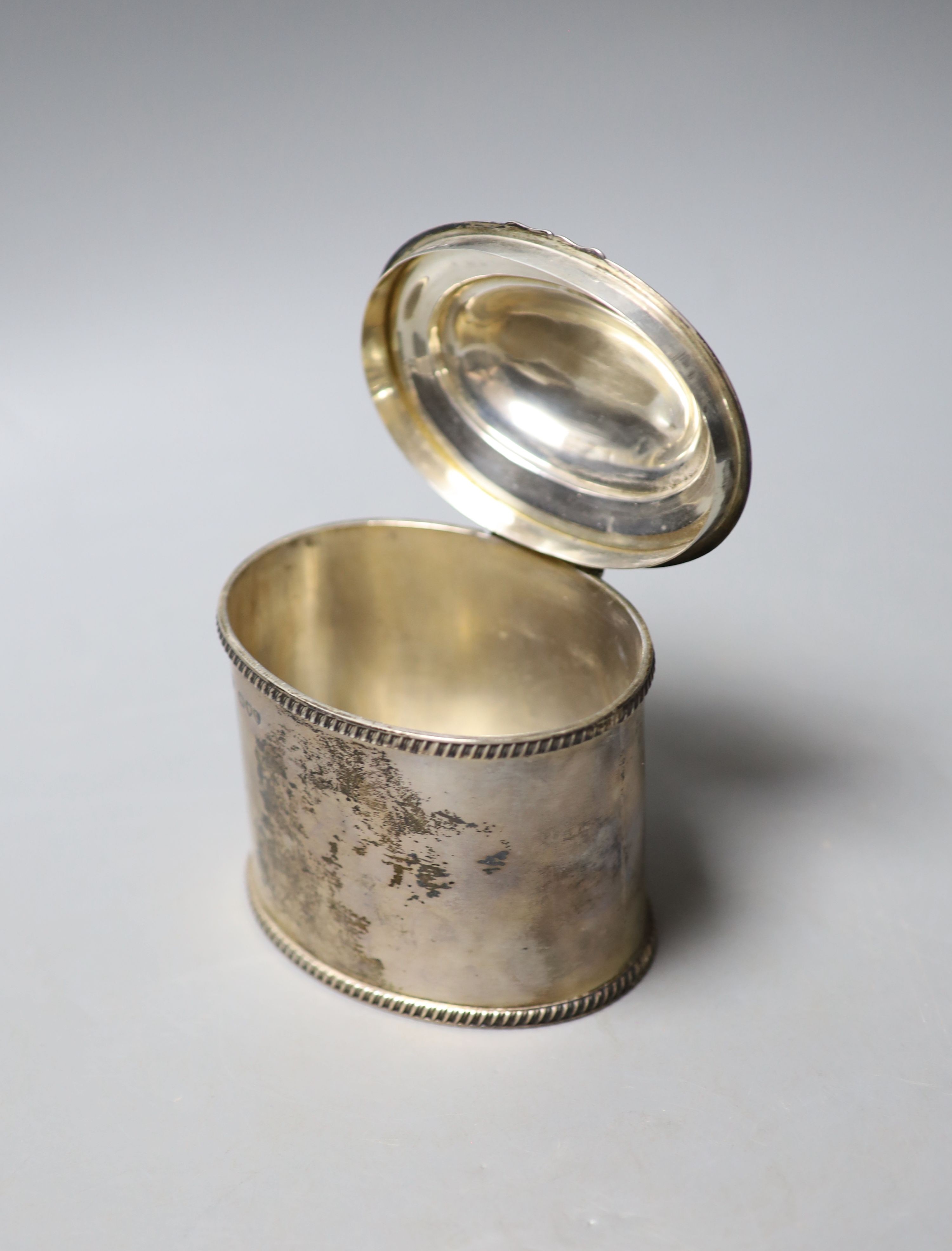 A late Victorian silver oval tea caddy, with gadrooned borders and hinged cover, Charles Stuart Harris, London, 1895, width 10.8cm, 9.5oz.